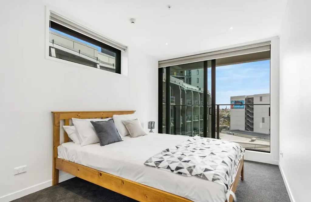 Bright Auckland bedroom with smooth white walls and professional interior paint finish by Above Board Interiors