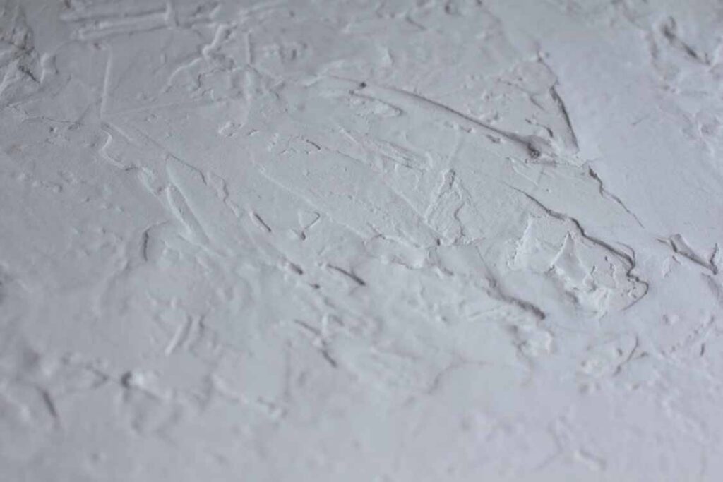 Rough plastered wall surface showing uneven texture and poor finishing before painting