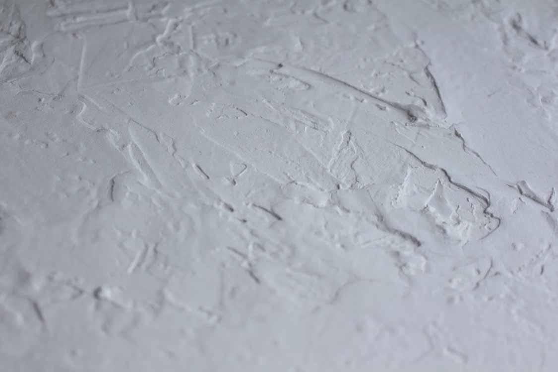 Rough plastered wall showing uneven texture and poor GIB stopping before painting in an Auckland