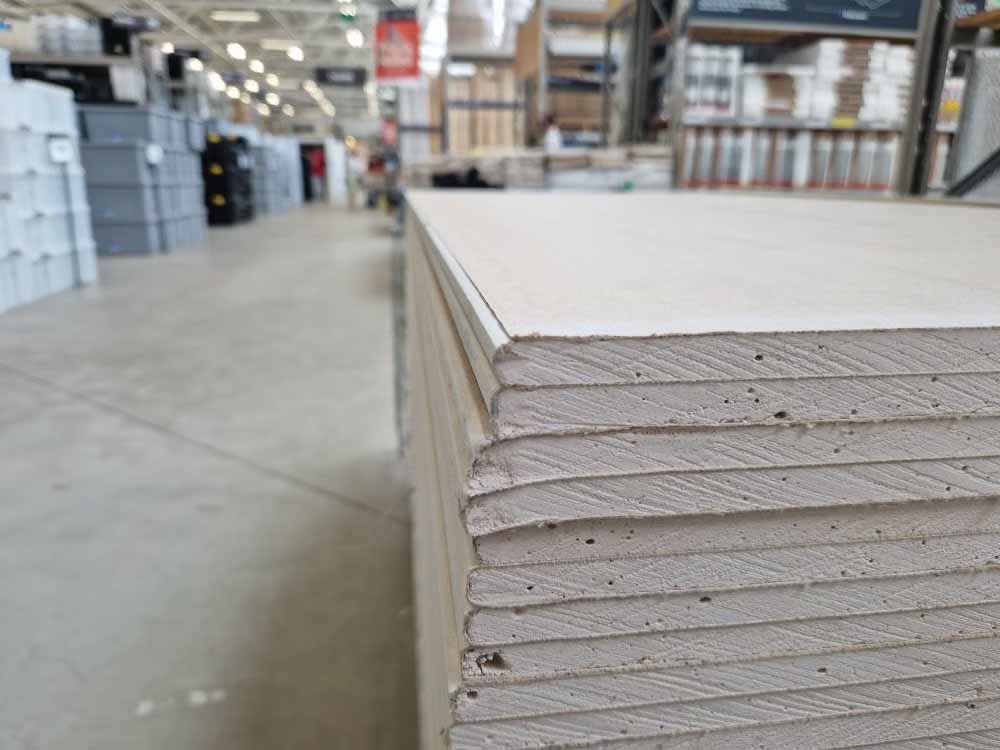 Stack of new plasterboard sheets waiting to be fixed, the first step before stopping and painting can start